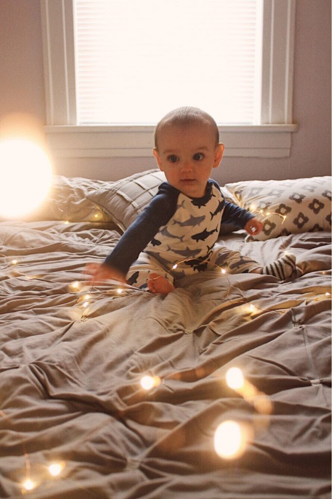 baby with fairy lights