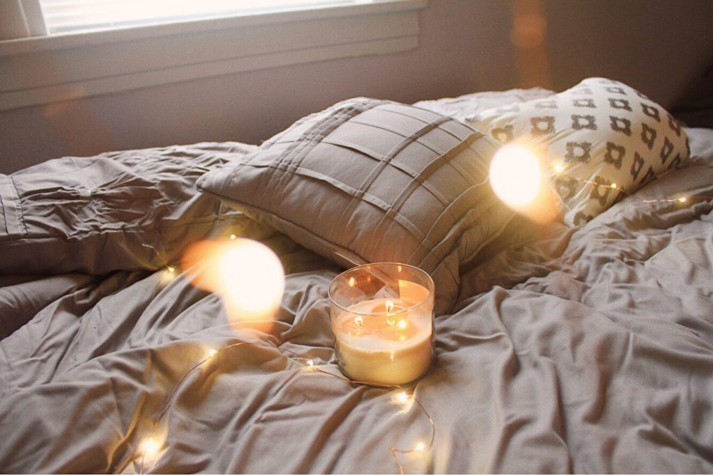 candle on a bed
