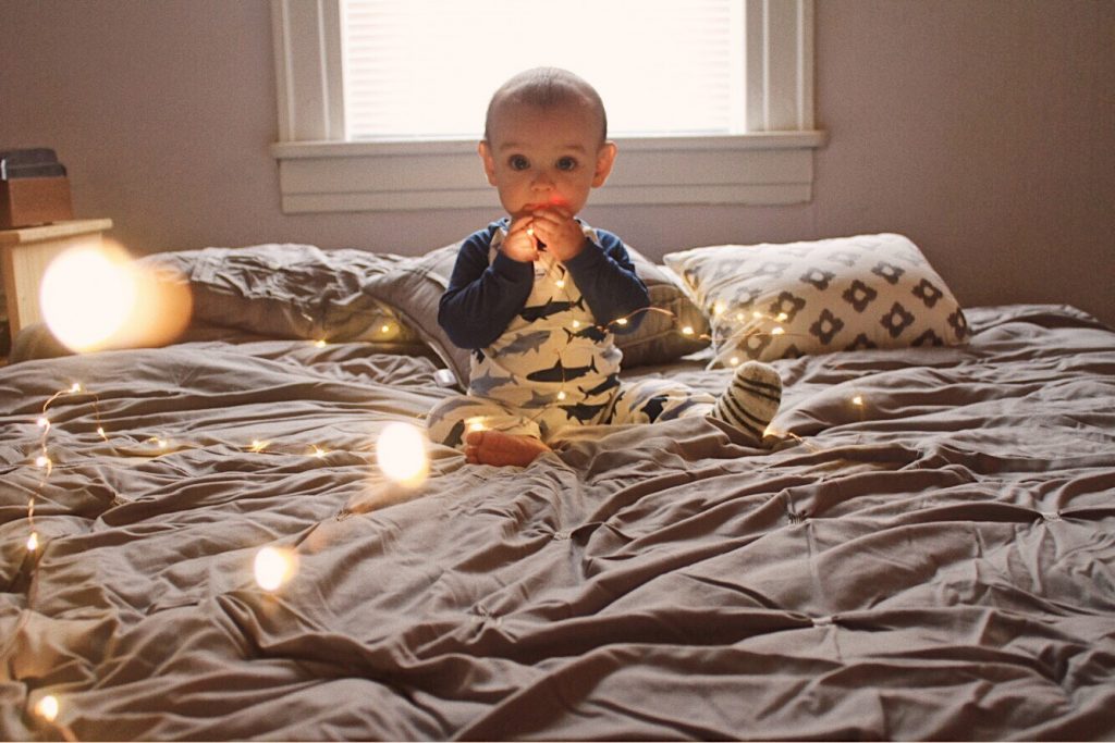 baby with fairy lights