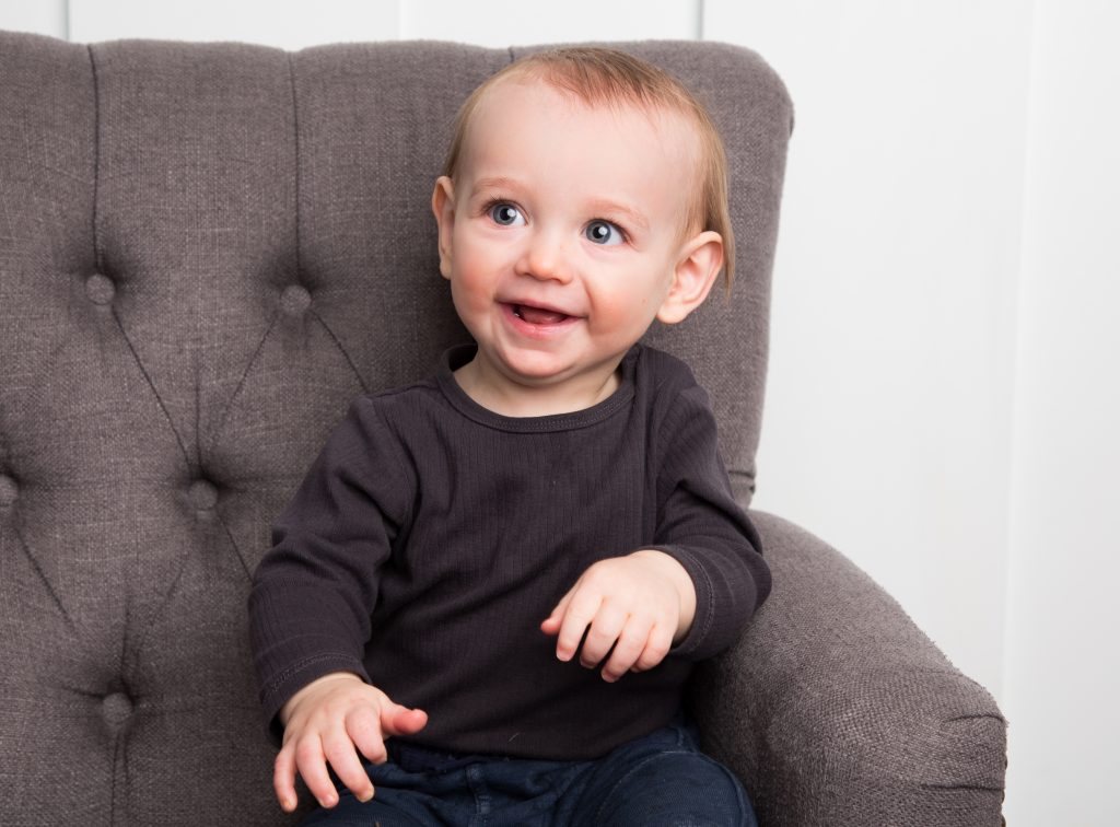 happy baby in a chair